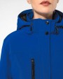 Softshells KARIBAN Gewatteerde softshell damesparka met capuchon voor bedrukking &amp; borduring